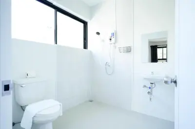 a white bathroom with a toilet and a sink at XX Snap Sukhumvit 1 -BTS Nana Bangkok in Makkasan