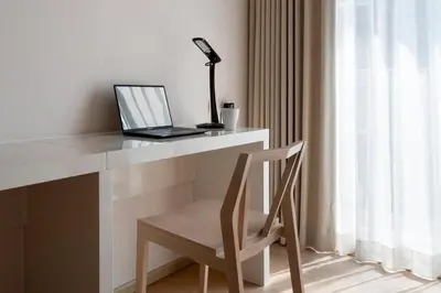 a laptop computer sitting on a white desk with a chair at 2BR2BA BTS Thonglor Rooftop Pool Gym BBQ Low in Bangkok