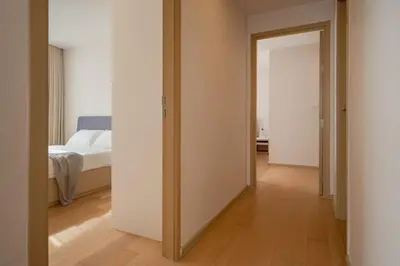 a room with a bedroom with a bed and a mirror at 2BR2BA BTS Thonglor Rooftop Pool Gym BBQ Low in Bangkok