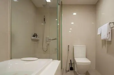 a bathroom with a shower and a toilet and a sink at 2BR2BA BTS Thonglor Rooftop Pool Gym BBQ Low in Bangkok