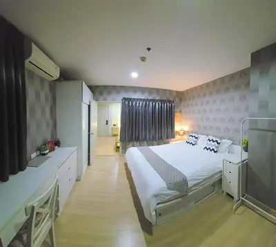 a bedroom with a large bed and a television at MahaNakhon Silom Sathon in the heart of Bangkok in Bangkok