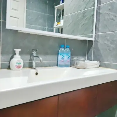 a bathroom sink with two soap bottles on it at MahaNakhon Silom Sathon in the heart of Bangkok in Bangkok