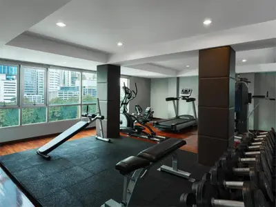 a gym with treadmills and exercise equipment in a building at Silom Lofts in Bangkok