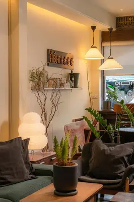 a living room with a couch and a table with plants at Nap Old Town in Bangkok