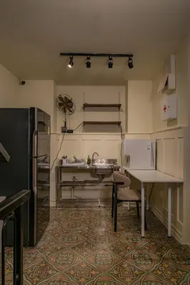 a kitchen with a sink and a table in it at Nap Old Town in Bangkok