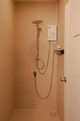 a shower with a hose in a bathroom at Nap Old Town in Bangkok