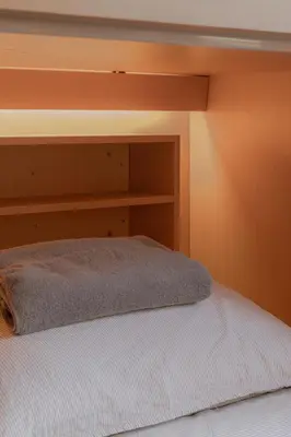 a bedroom with a bed with a wooden headboard at Nap Old Town in Bangkok