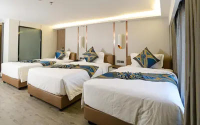 a group of four beds in a room at Marquis Hotel in Ban Bang Toei (1)