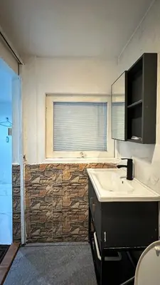 a bathroom with a sink and a window at Chubby5room12 in Ban Bang Phlat