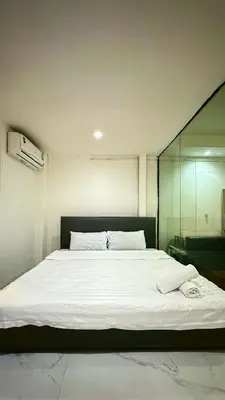 a bedroom with a large white bed in a room at Chubby5room12 in Ban Bang Phlat