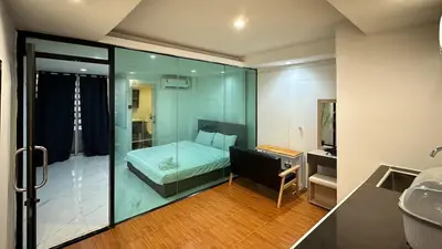 a bathroom with a bed and a shower and a sink at Chubby5room12 in Ban Bang Phlat