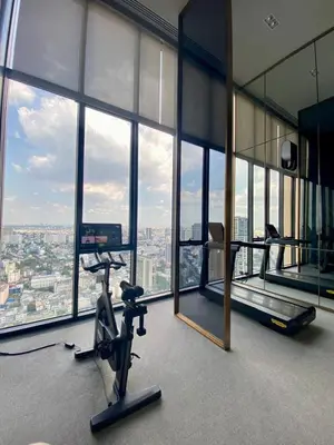 a gym in an office with a view of the city at The Crest Park Residences Monthly Rent only #2BR Apartment at Chatuchak #MrtBts in Bangkok