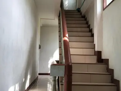 a staircase with a red railing in a building at 14 Hostel DMK airport in Bang Khen