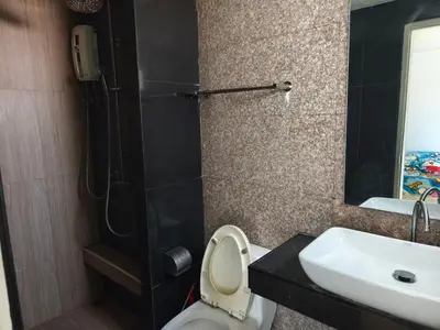 a bathroom with a toilet and a sink and a shower at mint apartment in Sathani Bang Su