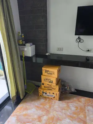 a stack of boxes sitting on the floor in a room at mint apartment in Sathani Bang Su