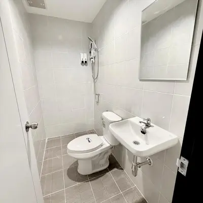 a bathroom with a toilet and a sink at z Rest Inn Silom - เรสท์ อินน์ สีลม in Bang Rak