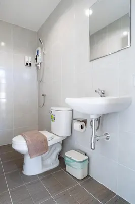 a bathroom with a toilet and a sink at z Rest Inn Silom - เรสท์ อินน์ สีลม in Bang Rak