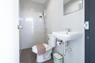 a bathroom with a toilet and a sink at XX Rest Inn Silom Bangkok in Bang Rak