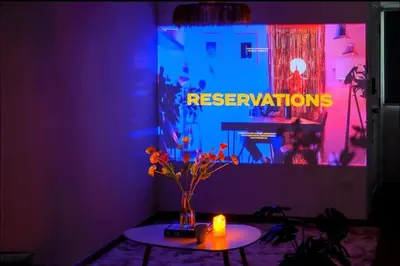 a purple room with a table with a vase of flowers at Common Living Bangkok in Bangkok