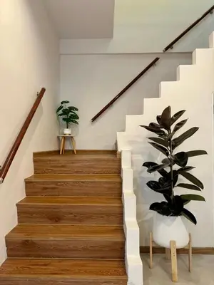 a staircase with a potted plant in a house at Common Living Bangkok in Bangkok