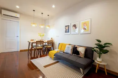 a living room with a couch and a table at Common Living Bangkok in Bangkok