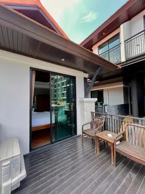 a deck with two benches and a bed on it at Yotaka Bangkok Hotel in Bangkok