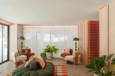 a living room with a couch and chairs at The Akyra Bangkok 11 in Bangkok