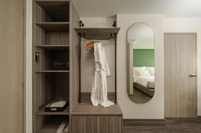 a dressing room with a mirror and a bed at The Akyra Bangkok 11 in Bangkok