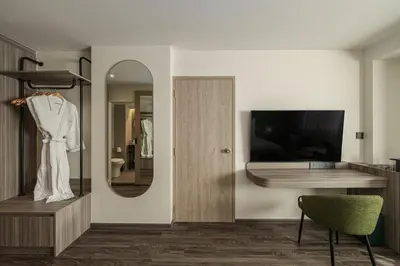 a dressing room with a mirror and a dressing table at The Akyra Bangkok 11 in Bangkok