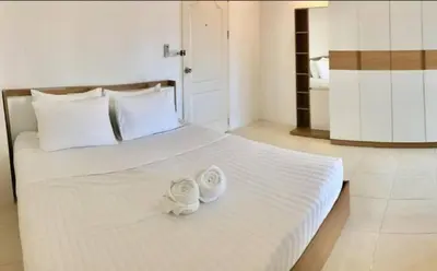 a bedroom with a bed with two towels on it at Grandview Ladprao Hotel in Bangkok