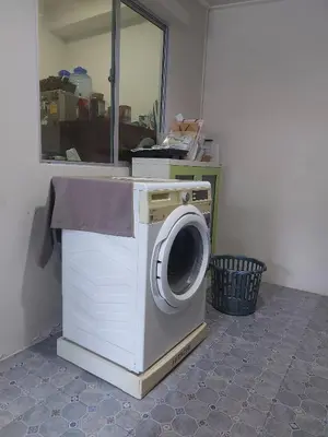 a washing machine in a room with a mirror at Cosy Preuksa House 120 in Bang Yai