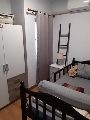 a bedroom with a bed and a ladder in it at Cosy Preuksa House 120 in Bang Yai