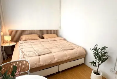 a bedroom with a large bed in a room at Chatuchak Haus in Bangkok