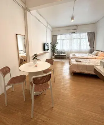 a living room with a bed and a table and chairs at Chatuchak Haus in Bangkok