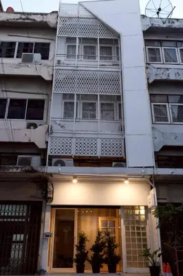 a white building with plants in front of it at Chatuchak Haus in Bangkok