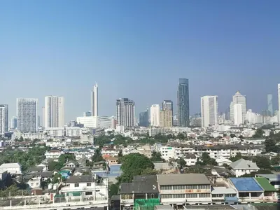 a city skyline with tall buildings in the background at BKK 2 BR apt near Sathon ICONSIAM firework view in Bangkok