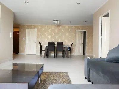 a living room with a table and chairs at BKK 2 BR apt near Sathon ICONSIAM firework view in Bangkok