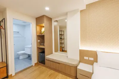 a bedroom with a bathroom with a toilet in it at Believeinn in Bangkok