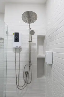 a shower with a shower head in a bathroom at Believeinn in Bangkok