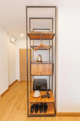 a shelf in a room with a table at Believeinn in Bangkok
