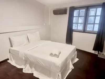 a white bed with a pair of engagement rings on it at xx zNap Yaowarat MRT วัดมังกร ใกล้สถานี 100 เมตร in Samphanthawong