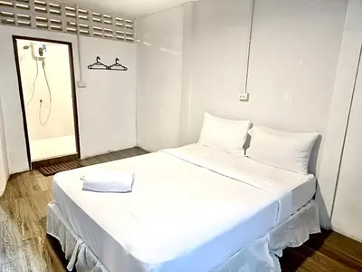 a large white bed in a room with a mirror at xx zNap Yaowarat MRT วัดมังกร ใกล้สถานี 100 เมตร in Samphanthawong