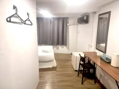 a room with a bed and a desk with a mirror at xx zNAP Yaowarat - สแนป เยาวราช MRT วัดมังกร in Samphanthawong