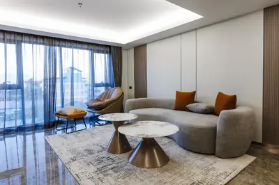 a living room with a couch and two tables at Maritztel Bangkok Hotel in Ban Bang Toei (1)