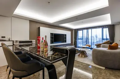 a living room with a glass table and a couch at Maritztel Bangkok Hotel in Ban Bang Toei (1)