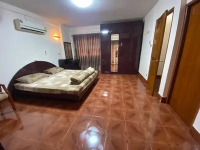 a bedroom with a bed and a wooden floor at Beautiful 2 story newly renovated bungalow house in Amphoe Phra Khanong
