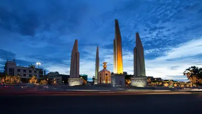 a monument with obelisks in a city at night at Thanabhumi in Bangkok