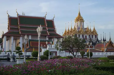 a group of buildings with gold domes in a park at Thanabhumi in Bangkok
