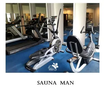 a gym with two treadmills and two exercise bikes at Palette Bangkok Natural Resort and Spa in Bangkok
