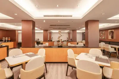 a waiting room with tables and chairs and a salon at Palette Bangkok Natural Resort and Spa in Bangkok